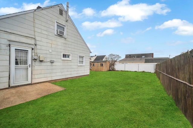 back of property featuring a storage shed and a yard