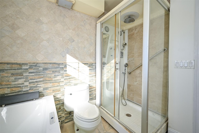 bathroom with a shower with door and toilet