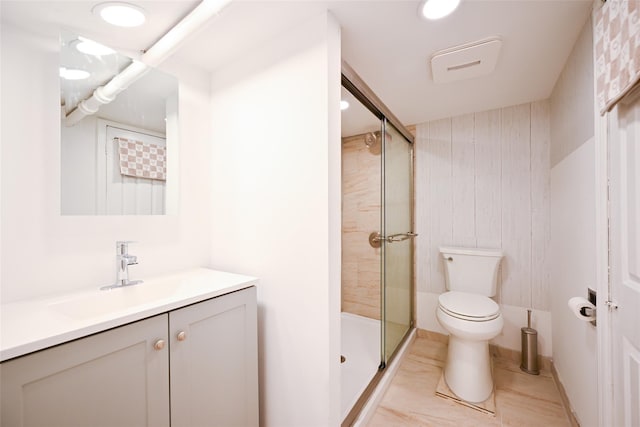 bathroom with vanity, toilet, and a shower with shower door