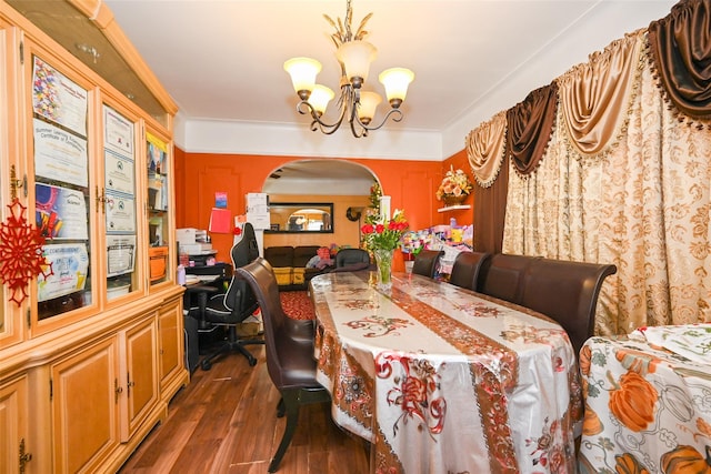 dining space with dark hardwood / wood-style flooring and a chandelier