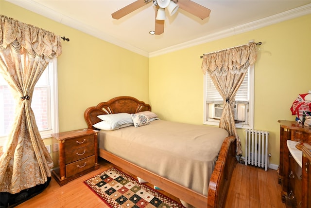 bedroom featuring light hardwood / wood-style floors, radiator, crown molding, and ceiling fan