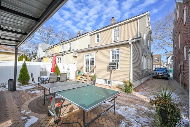 back of property with cooling unit and a patio area