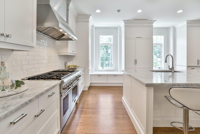 2 Weaver St Unit 3, Scarsdale, NY 10583 - kitchen featuring white cabinets, wall chimney exhaust hood, double oven range, and light stone counters