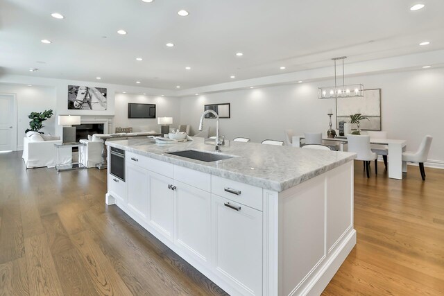 2 Weaver St Unit 3, Scarsdale, NY 10583 - kitchen featuring pendant lighting, a center island with sink, white cabinetry, and sink