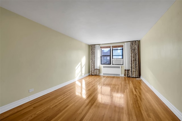 unfurnished living room with light wood-type flooring and radiator heating unit