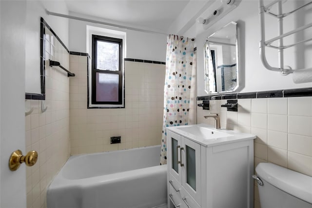 full bathroom featuring shower / bath combo, toilet, tile walls, and vanity