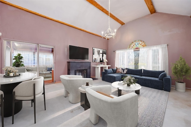 carpeted living room with high vaulted ceiling, beamed ceiling, a healthy amount of sunlight, and a notable chandelier