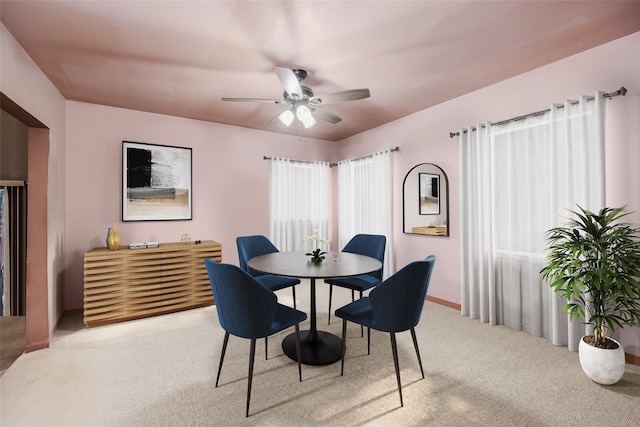 dining room featuring ceiling fan and light colored carpet