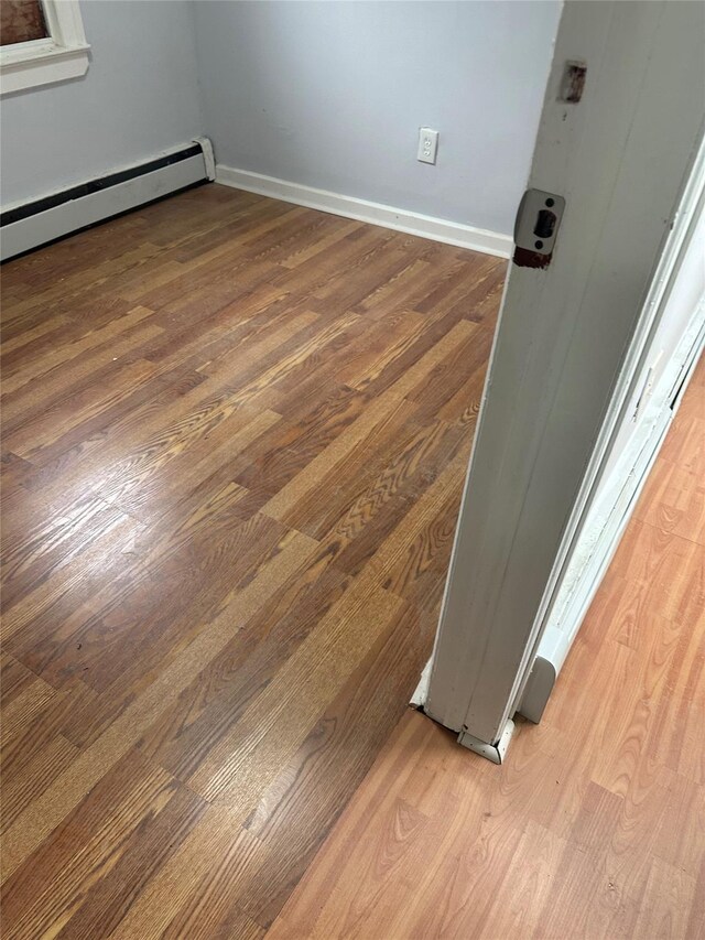 room details with wood-type flooring and a baseboard radiator