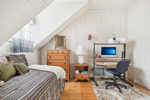 bedroom featuring wood walls and light wood-type flooring