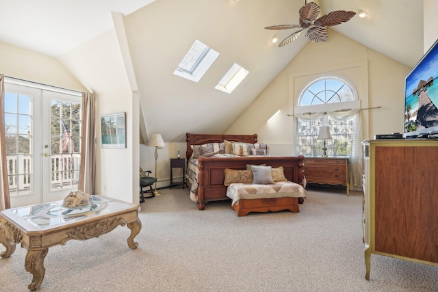 bedroom with access to outside, light carpet, and vaulted ceiling with skylight