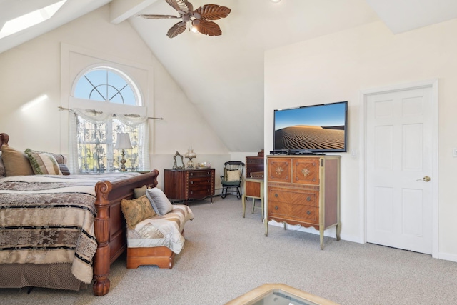 carpeted bedroom featuring lofted ceiling with skylight and ceiling fan