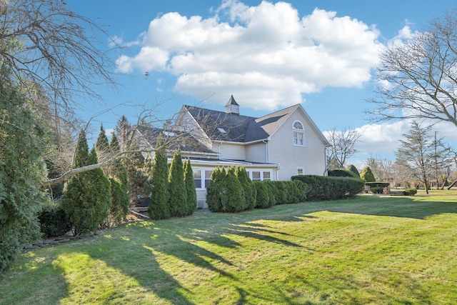 view of side of property featuring a yard