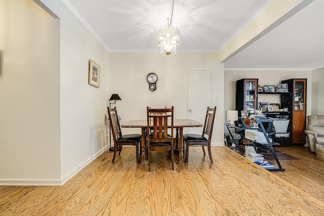 dining space with crown molding, a notable chandelier, and light wood-type flooring