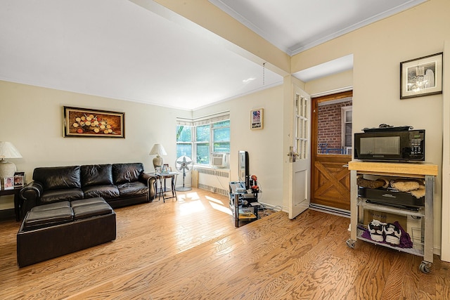 living room featuring radiator heating unit, light hardwood / wood-style flooring, cooling unit, and crown molding