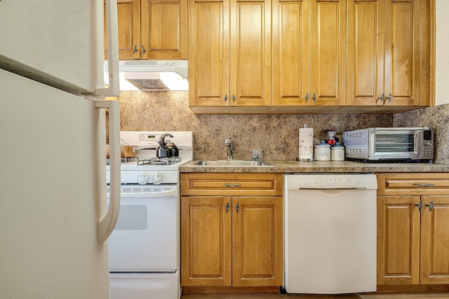 kitchen with decorative backsplash, white appliances, and sink