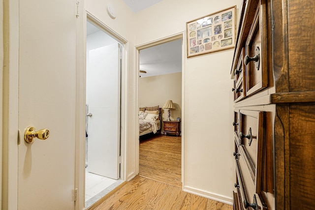 corridor with light hardwood / wood-style floors