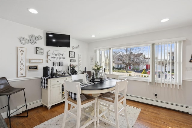 dining space featuring hardwood / wood-style flooring and baseboard heating