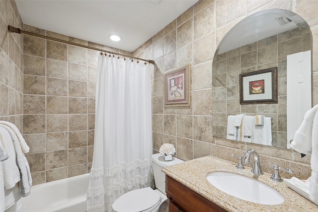 full bathroom with shower / bath combination with curtain, vanity, toilet, and tile walls