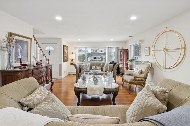 living room featuring a baseboard heating unit and light hardwood / wood-style flooring