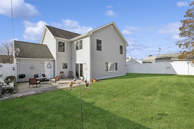 back of house with a yard and a patio