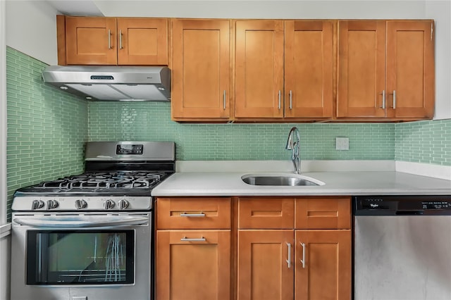 kitchen featuring decorative backsplash, appliances with stainless steel finishes, sink, and range hood