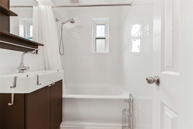 bathroom with shower / bathtub combination with curtain, plenty of natural light, and sink