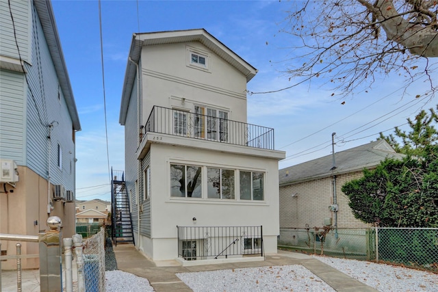 rear view of property with a balcony