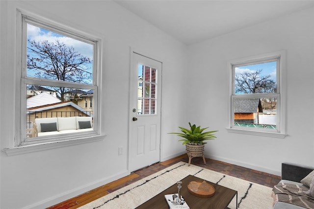 interior space with plenty of natural light and dark hardwood / wood-style floors