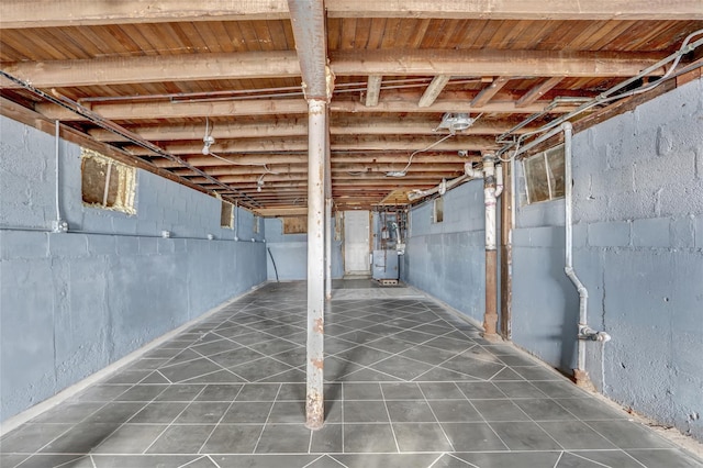 basement with dark tile patterned flooring