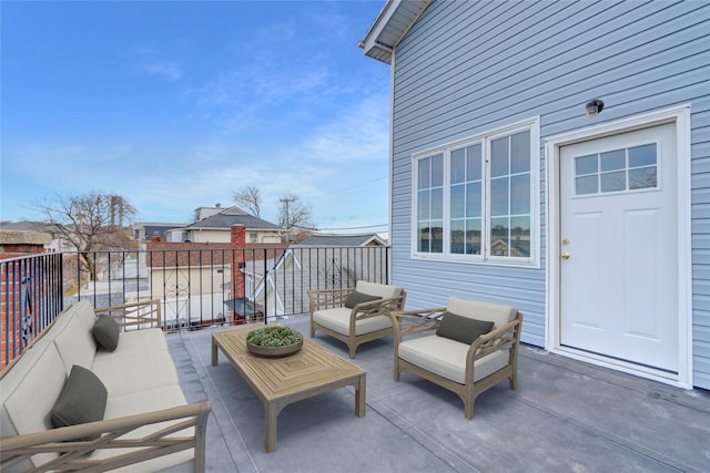 view of patio featuring a balcony and an outdoor hangout area