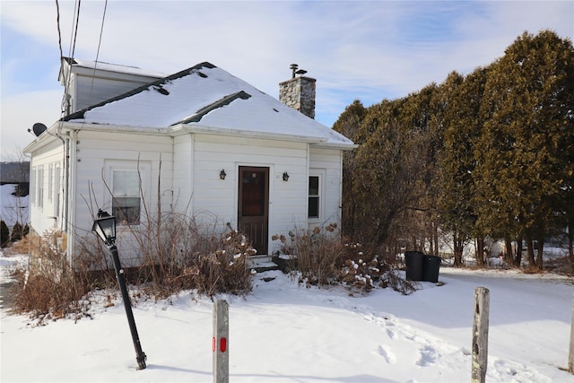 view of front of house featuring a chimney