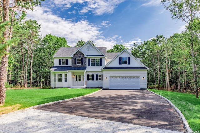 view of front of property with a front yard and a garage