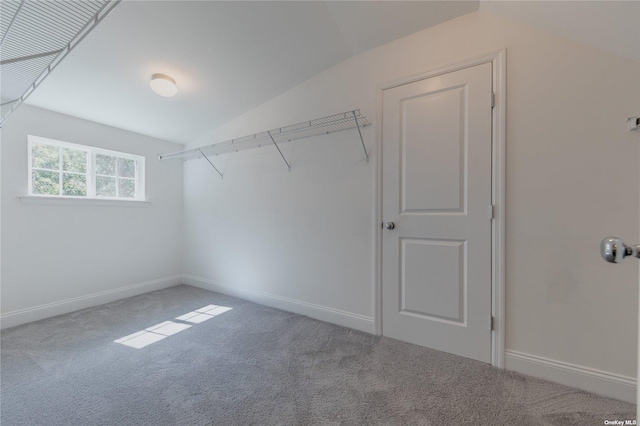 walk in closet with carpet flooring and vaulted ceiling