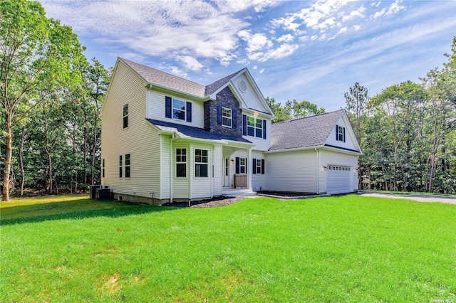 view of front of house featuring central AC, a front lawn, and a garage