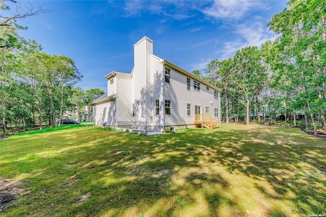 rear view of house with a yard