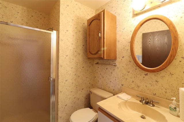 bathroom featuring vanity, an enclosed shower, and toilet