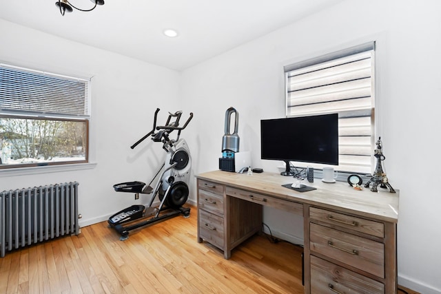 office area featuring radiator heating unit and light hardwood / wood-style floors