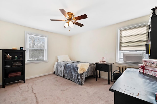 bedroom with radiator heating unit, carpet flooring, and ceiling fan