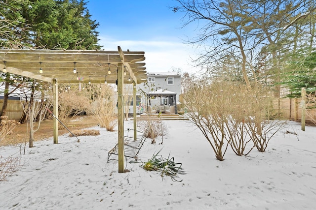 yard covered in snow with a pergola