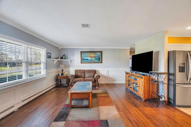 living room with hardwood / wood-style floors, crown molding, and a baseboard radiator