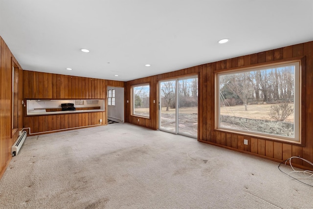 unfurnished living room featuring a baseboard radiator and light carpet