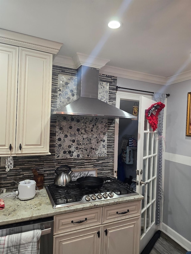 kitchen featuring backsplash, wall chimney exhaust hood, crown molding, and stainless steel gas stovetop