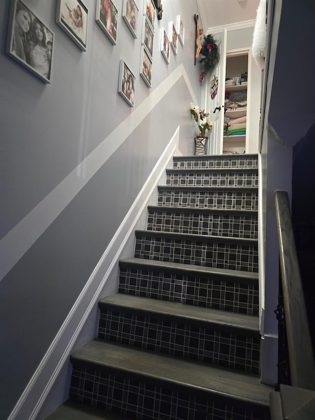 staircase featuring crown molding