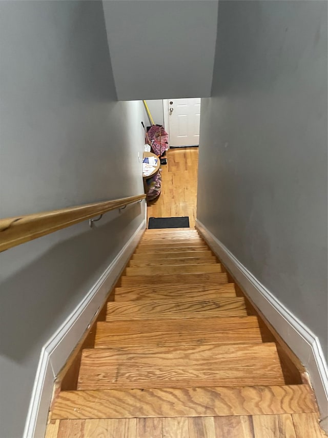 stairs with hardwood / wood-style flooring