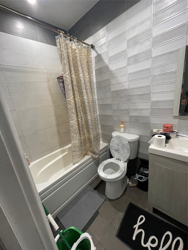 bathroom with tile walls, tile patterned flooring, shower / bath combo, and toilet