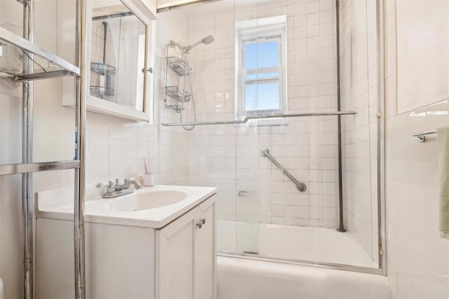 5635 Netherland Ave Unit 4E, Bronx, NY 10471 - bathroom with tasteful backsplash, vanity, tile walls, and shower / bath combination with glass door