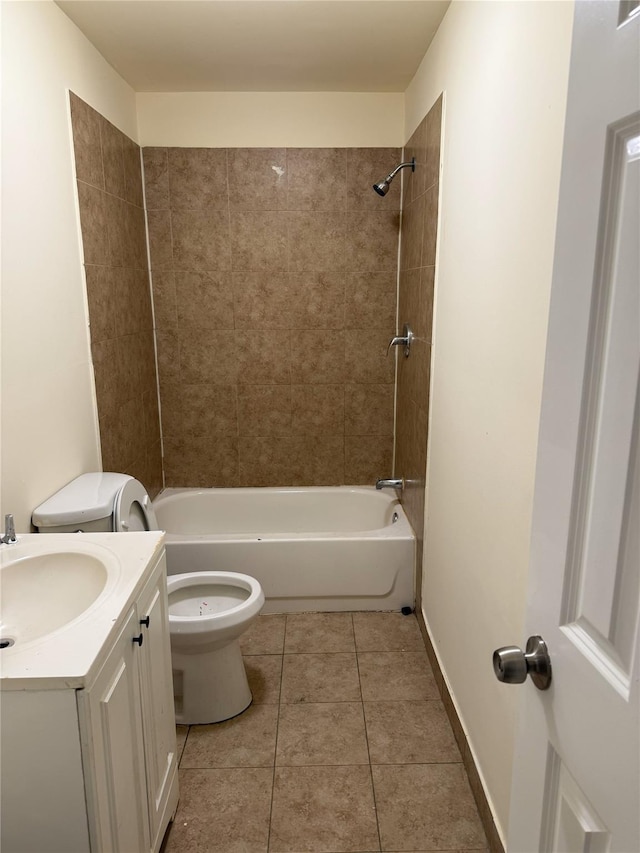 full bathroom featuring toilet, tiled shower / bath, tile patterned floors, and vanity