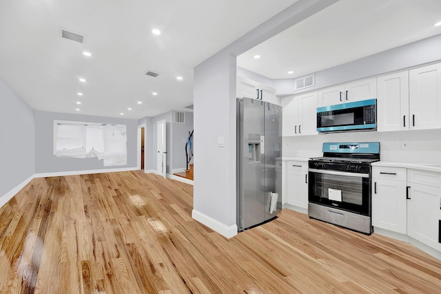 kitchen featuring light hardwood / wood-style floors, white cabinetry, and appliances with stainless steel finishes