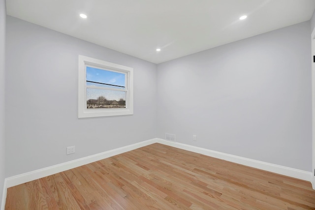 unfurnished room with light wood-type flooring